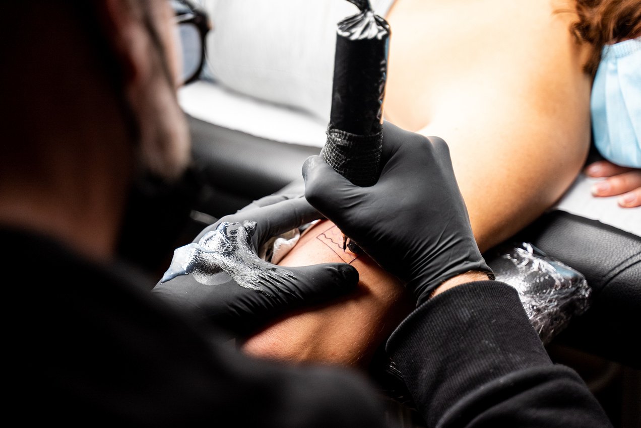 Tattoo Artist Doing Tattoo on a Person's Arm